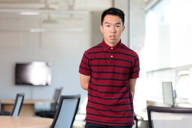 istock An shy nerd student standing in the school library 2165816802