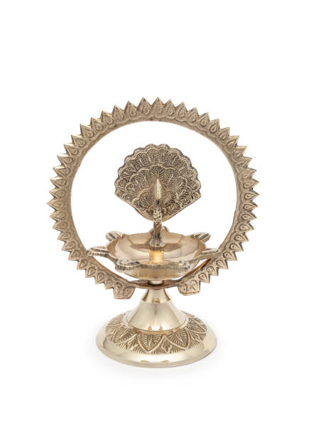 istock A designer brass diya, a traditional Hindu pooja accessory, isolated on a white background. 2165819321