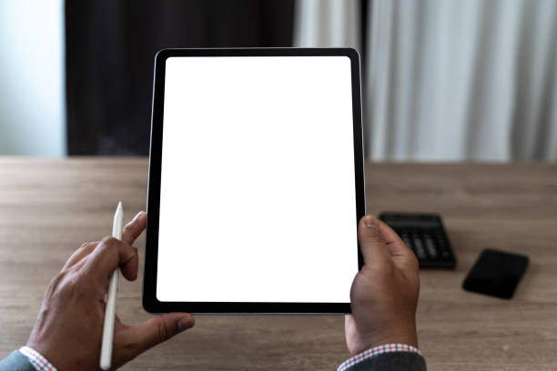istock hands of a man holding blank tablet a mockup. iPad digital tablet workspace table 2165819415