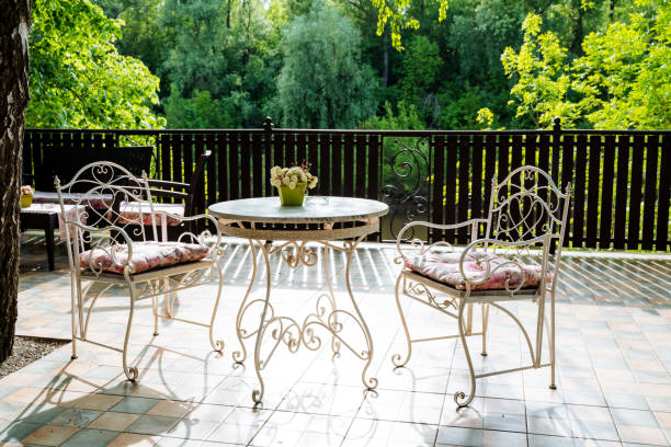 istock A table and chairs on a patio with trees in the background 2165820460