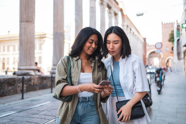 istock Two friends exploring Milano Italy and looking at smartphone 2165821814