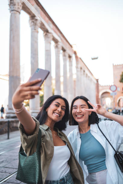 istock Two friends taking a selfie while visiting Milan, Italy 2165821820