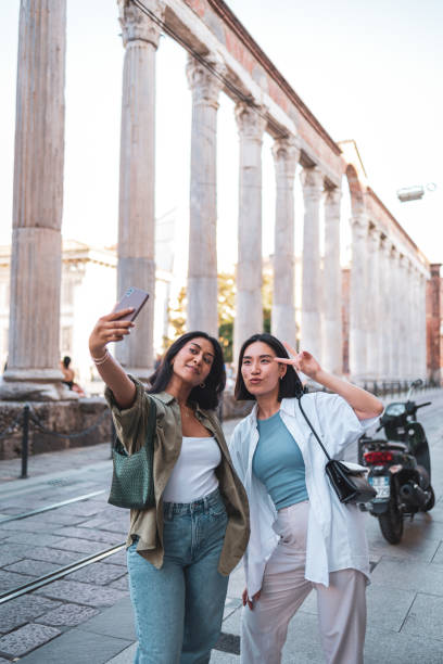 istock Two friends taking a selfie in front of ancient columns in Milan 2165821821
