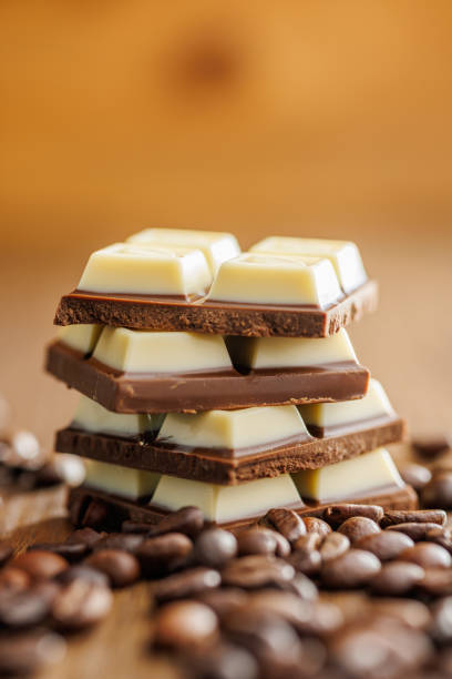 istock White light dark chocolate bars and coffee beans on wooden table. 2165821934