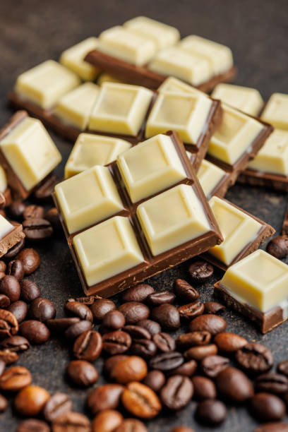 istock White light dark chocolate bars and coffee beans on black table. 2165822001