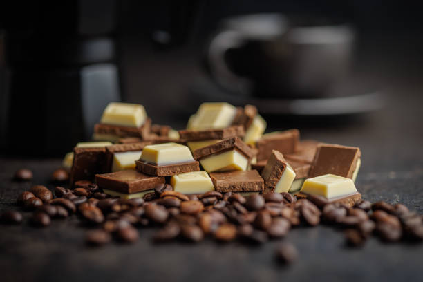 istock White light dark chocolate bars and coffee beans on black table. 2165822030