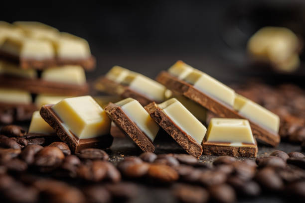 istock White light dark chocolate bars and coffee beans on black table. 2165822043