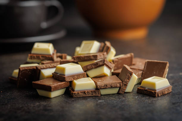 istock White light dark chocolate bars and coffee beans on black table. 2165822044