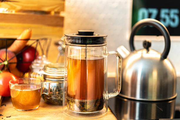 istock tea kettle with piston. Kitchen interior table. Spices jars, hot drink preparation. 2165826875