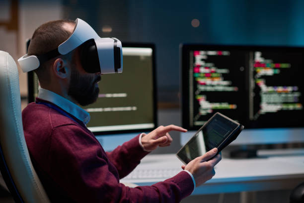 istock Bearded Man Wearing VR Headset in Blue Lights 2165829864