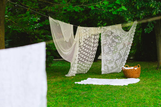 istock Washing day with laundry on clothesline, White clean sheets outdoors. 2165831032