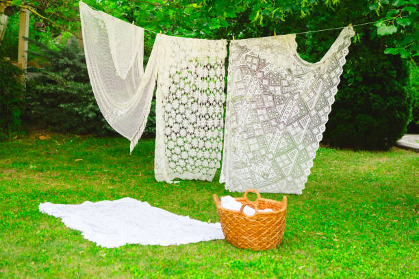 istock Washing day with laundry on clothesline, White clean sheets outdoors. 2165831044