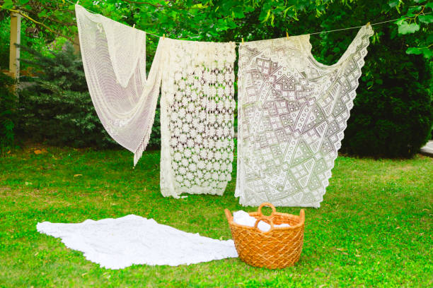 istock White laundry on clothesline in garden. White curtains drying in the sun. 2165831047