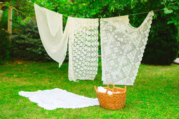istock White laundry on clothesline in garden. White curtains drying in the sun. 2165831059
