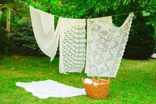 istock Washing day with laundry on clothesline, White clean sheets outdoors. 2165831068