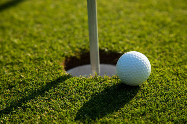 istock Closeup Golf ball on green grass on course 2165834429
