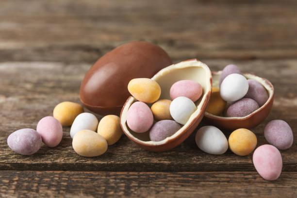 istock COLOURED EASTER EGGS. Easter celebration concept. Happy Easter. Chocolate sweet eggs. Candies on textured wooden table. Space for text.Copy space 2165834912