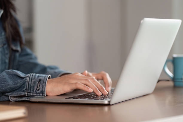 istock Young Woman Studying Online Through a Conference Program on a Laptop at Home 2165838021