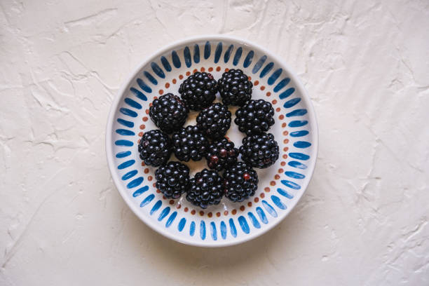 Fresh ripe blackberries on wooden table. Space for text