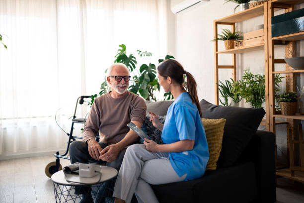 istock Caring Nurse Assisting Elderly Man at Home 2165842851