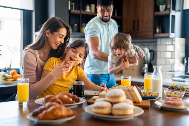 istock Diverse Family Enjoys Breakfast Together in Sunny Kitchen 2165843077