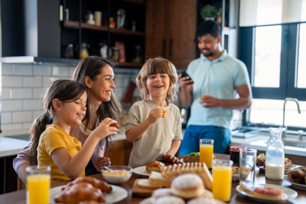 istock Joyful Family Making Breakfast in Sunny Kitchen 2165843099