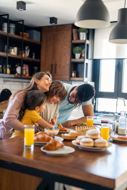 istock Joyful Family Engaged in Breakfast Preparation in Sunny Kitchen 2165843104