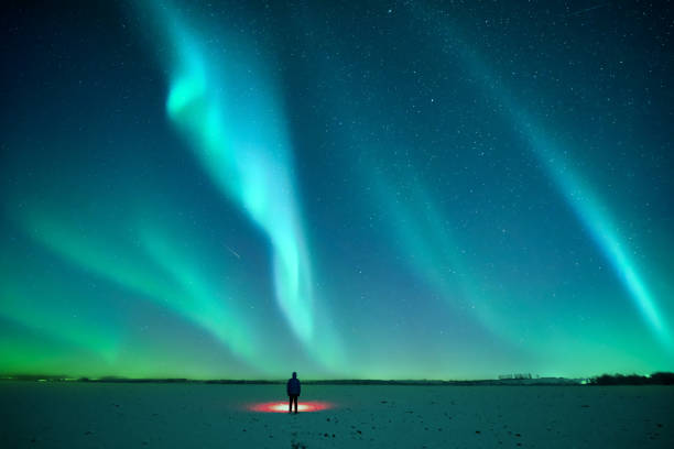 istock Tourist with red flashlight on snowy field 2165843282