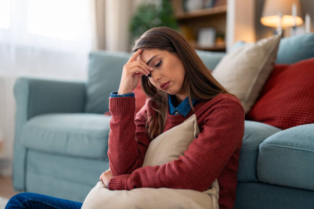 istock Stressed Woman Clutching Pillow at Home 2165843378