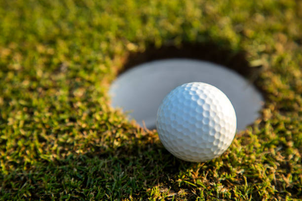 istock Closeup Golf ball on green grass on course 2165844246