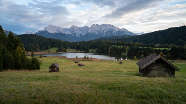 istock Alpine Cabins by a Lake with Mountain Backdrop 2165844493