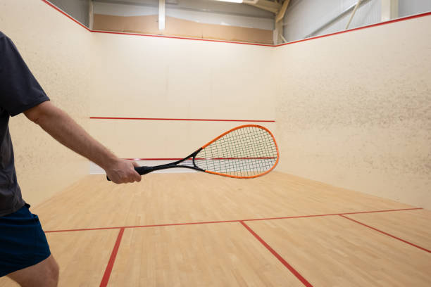 istock Unrecognizable man waving a squash racket inside court 2165845778