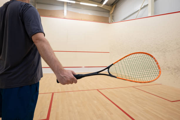 istock Unrecognizable man waving a squash racket inside court 2165845786