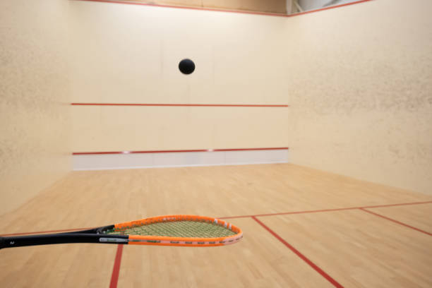 istock Squash racket and ball inside court, ball bouncing off the racket 2165845795