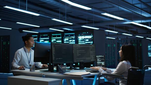 istock Person with paraplegia working in inclusive server hub workspace, typing on PC 2165848843