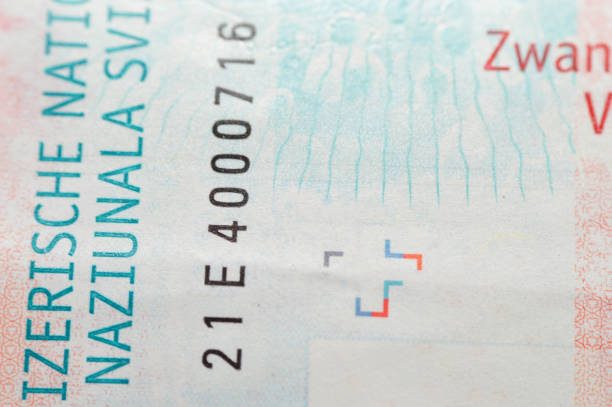 istock Switzerland 20 Twenty Francs, butterflies, a light projected at a screen, human eye iris lines, hand, security stripe, light emissions map of Switzerland 2165849130