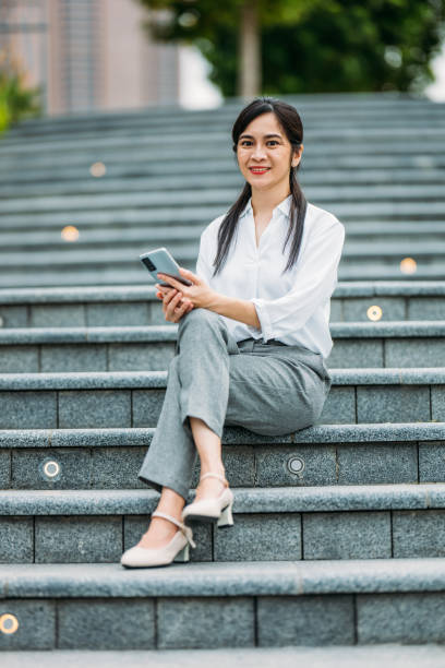 istock Cityscape Reflections: A Businesswoman's Pause 2165849196