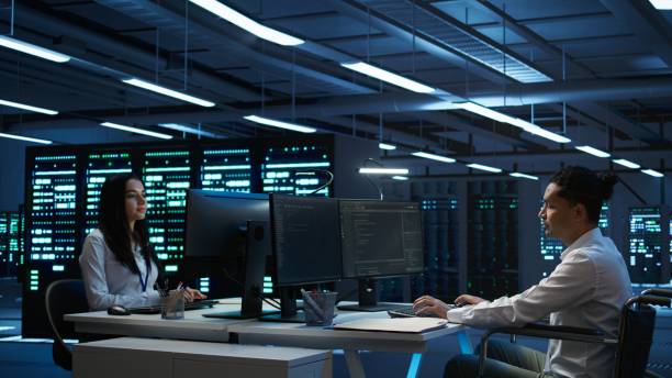 istock Woman in wheelchair doing maintenance on server room infrastructure 2165849545