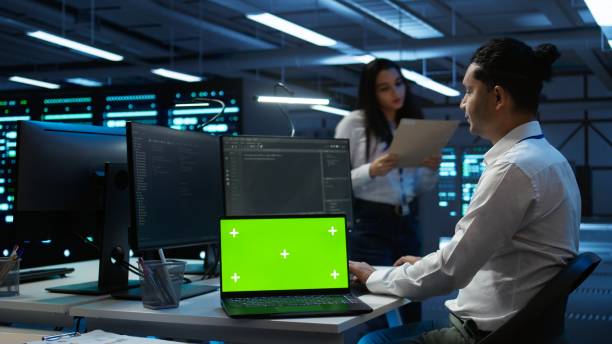 istock Woman doing maintenance on server room infrastructure using mockup laptop 2165850484
