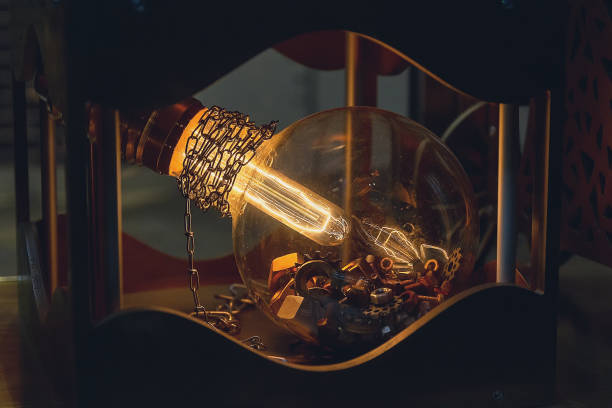 Macro shot of a vintage valve embedded in a handcrafted lamp made from charred wood. A detailed industrial element captured with shallow depth of field.