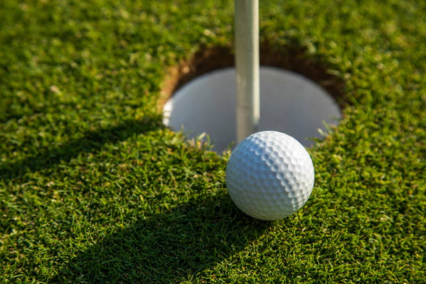 istock Closeup Golf ball on green grass on course 2165851647