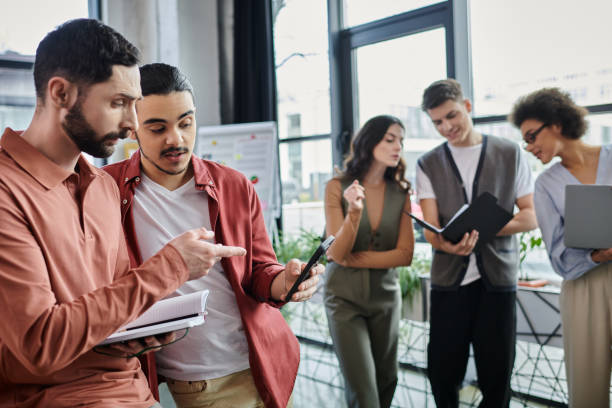 istock Multicultural business team collaborating in modern office environment 2165851890