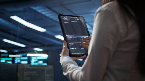 istock Close up of woman doing maintenance in server room using tablet 2165852148