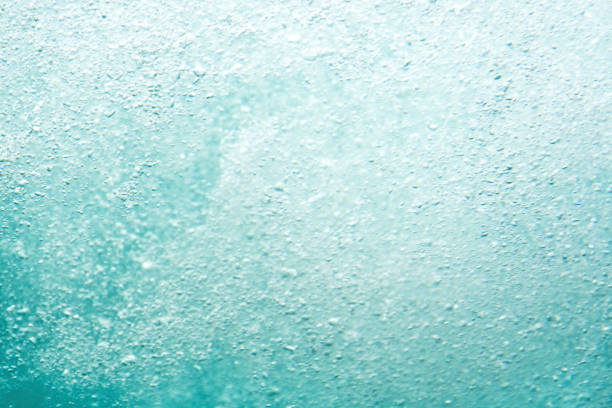 An abstract image of water bubbles in a turquoise hue. This can be used for background and texture purposes.