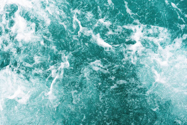 istock A close-up image of teal-colored water with white foam 2165852589
