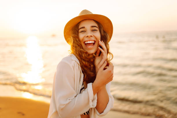 istock Young woman walking barefoot on the beach, sunrise. 2165852965