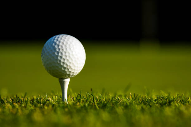 istock Closeup Golf ball on green grass on course 2165853121