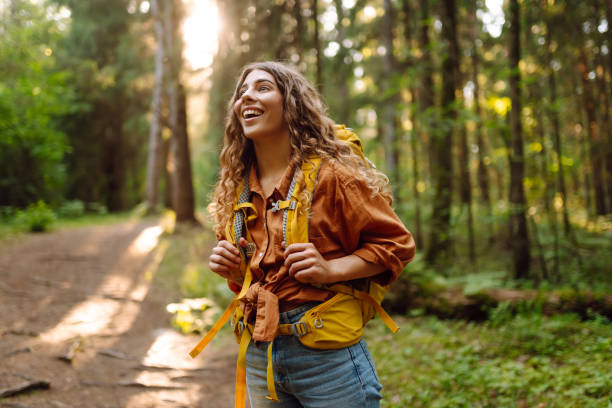 istock Young woman enjoys the forest view. 2165853950