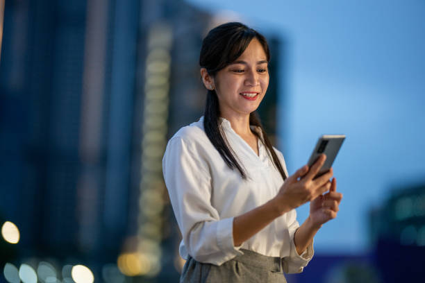istock Urban Pulse: A Businesswoman's Strategic Path Through the Nighttime Streets 2165855049