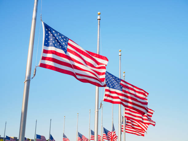 istock American flags waving in the wind, clear blue sky background 2165857646
